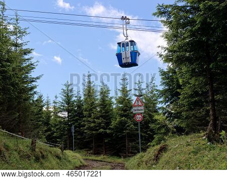 Cable Car In Garmisch-partenkirchen, Wank Mountain, With Warning Sign Of Cable Car Running Low.