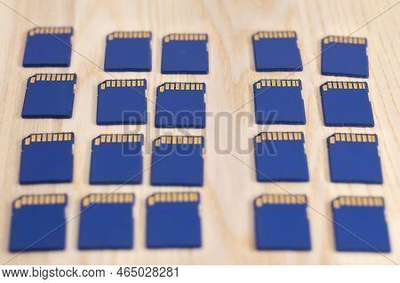 Multiple Sdhc Memory Cards On Wooden Surface - Shallow Focus