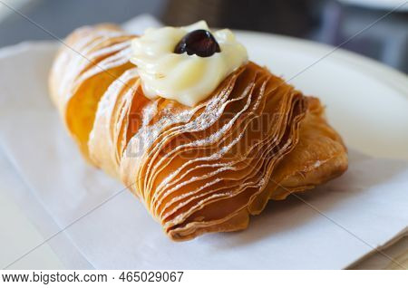 Sfogliatellla Riccia (also Called Lobster Tail In The Us) On A White Plate. The Concept Of Tradition