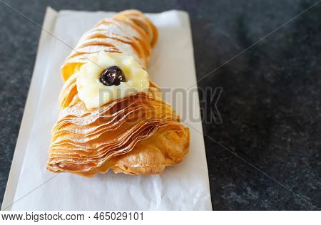 Sfogliatellla Riccia (also Called Lobster Tail In The Us) On Kraft Paper. The Concept Of Traditional