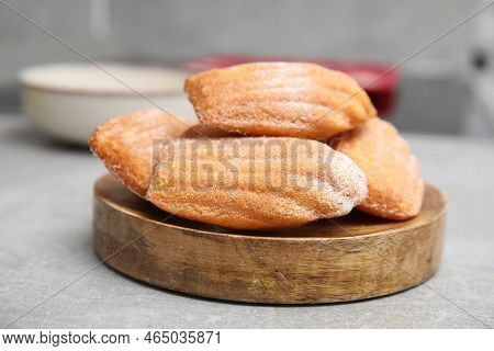 Wooden Board With Madeleine Cookies On Grey Table, Closeup