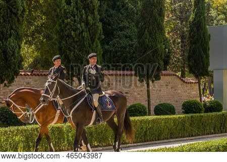 Istanbul, Turkiye; Sept. 7, 2022: Two Unidentified Military Personal Riding Horses Through Park.