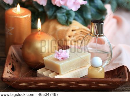 Spa Concept With Candles In Gold And Pink. Handmade Olive Soap, Facecloth, Towel, Candles And Pink C