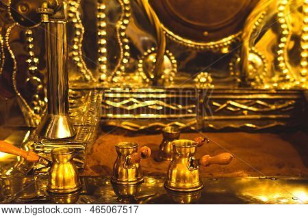 Dubai, Uae - 12th October, 2022: Golden Coffee Pots With Hot Sand. Arabic Coffee Preparation Methods