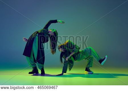Inspiration. Young Stylish Flexible Girls In Modern Attires Dancing Contemp Style Dance Isolated Ove
