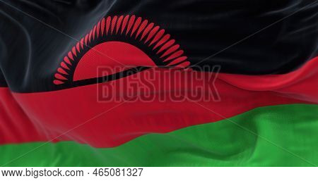 Close-up View Of Malawi National Flag Waving. The Republic Of Malawi Is A Landlocked Country In Sout