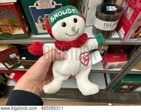 New Hope, Minnesota - November 6, 2022: Hand Holds Up A Snowden Christmas Plush Toy. Snowden Was A C
