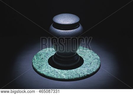 Cremation Urn On Marble And Black. Low Key Image.