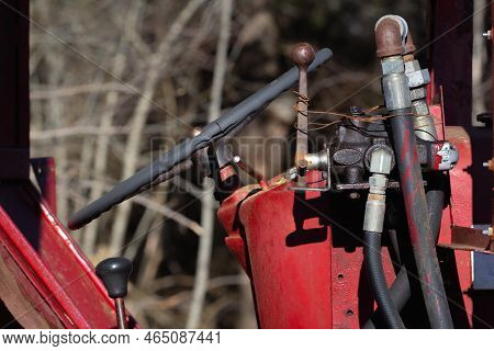Old Farm Tractor Hydraulic Lines And Steering Wheel