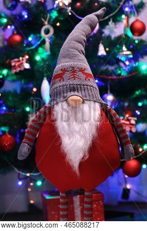 Christmas Gnome Standing On The Background Of The Christmas Tree