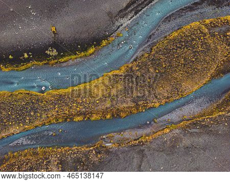 Drone Shot River Running Trough Black Volcanic Sand