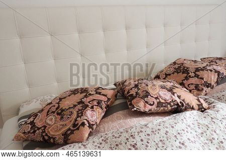 Pink Decorative Pillows On The Bed Linen. Double Bridal Bed With Pillows And Thick Feather Duvet. Be
