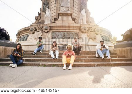 Addicted Group Of Friends Using Their Smart Phones. Individualistic People Focused On Their Mobiles 