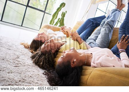 Three Woman Laughing And Having Fun Together. Happy Smiling Female Friends Indoors At Home.