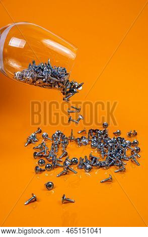 Dropped Many Metal Self-tapping Screws Made Of Steel In A Glass, In Bucket Jar. Self-tapping Screw F