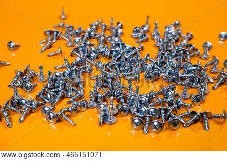 Many Metal Self-tapping Screws Made Of Steel In A Glass, In Bucket Jar. Self-tapping Screw For Metal