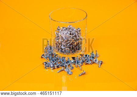 Many Metal Self-tapping Screws Made Of Steel In A Glass, In Bucket Jar. Self-tapping Screw For Metal