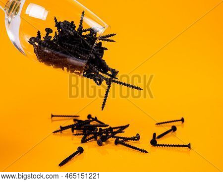 Dropped Many Metal Self-tapping Screws Made Of Steel In A Glass, In Bucket Jar. Self-tapping Screw F