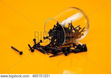 Many Metal Self-tapping Screws Made Of Steel In A Glass, In Bucket Jar. Self-tapping Screw For Metal