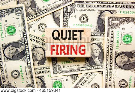 Quiet Firing Symbol. Concept Words Quiet Firing On Wooden Blocks. Beautiful Background From Dollar B