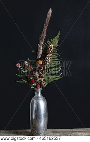 Beautiful Red Dried Flower Arrangement In A Metal Vase.