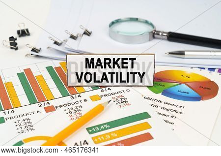 Business Concept. On The Business Charts Lies A Magnifying Glass, A Pen And A Sign With The Inscript