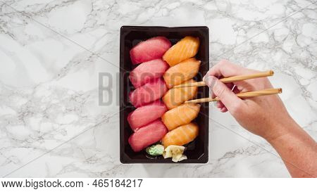 Flat Lay. Pre-packaged Variety Of Sushi And Sushi Rolls In A Plastic Tray.
