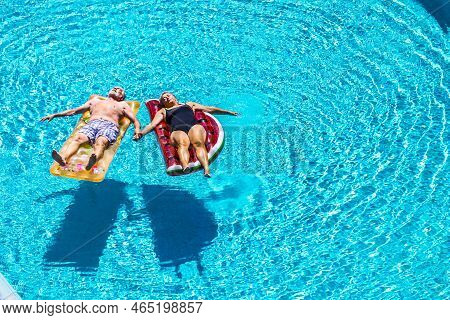 Total Relax For Happy Mature Senior Retired People Lay Down On Coloured Lilos Inflatable Mattress On