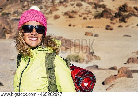 Cheerful Happy Young Caucasian Woman Smile And Enjoy Trekking Outdoor Leisure Activity With Mountain