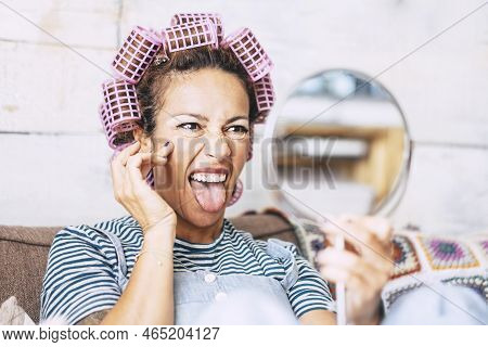 Funny And Crazy Adult Beautiful Attractive Woman Doing  Expressions In The Mirror Getting Ready With