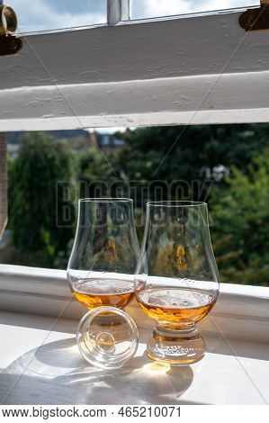 Two Glasses Of Single Malt Scotch Whisky Served On Old Window Sill In Scottisch House With View On O