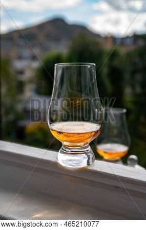 Glass Of Single Malt Scotch Whisky Served On Old Window Sill In Scottisch House With View On Old Par