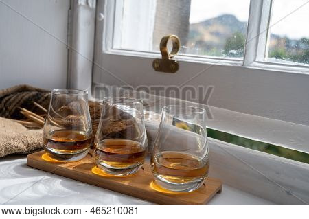 Flight Of Single Malt Scotch Whisky Served On Old Wooden Window Sill In Scottisch House In Edinburgh
