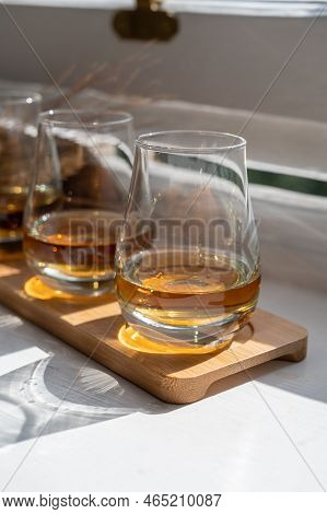Flight Of Single Malt Scotch Whisky Served On Old Wooden Window Sill In Scottisch House In Edinburgh