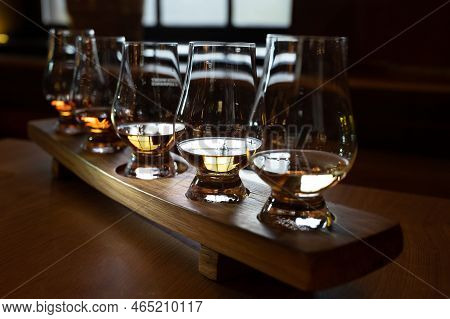 Flight Of Single Malt Scotch Whisky In Glasses Served In Whiskey Bar In Edinburgh, Uk