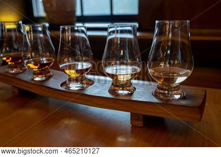 Flight Of Single Malt Scotch Whisky In Glasses Served In Whiskey Bar In Edinburgh, Uk