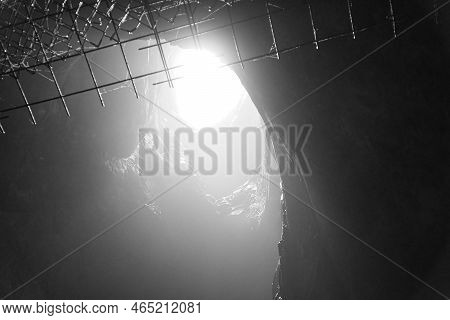 Rock Cave With Hole Through Which Light Shines. Underworlds In Sweden. Mystical Atmosphere. Nature S