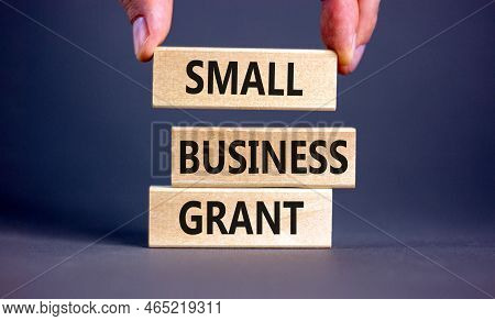 Small Business Grant Symbol. Concept Words Small Business Grant On Wooden Blocks On A Beautiful Grey