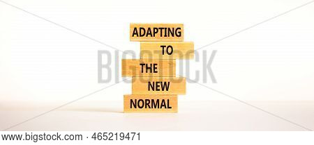 Adapting To The New Normal Symbol. Wooden Blocks With Words Adapting To The New Normal On Beautiful 
