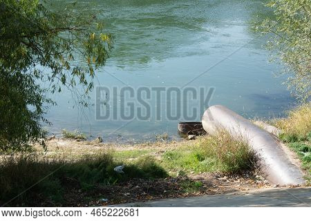 Sewage From The Sewer Polluting A Lake Or Water Gushing From The Sewer To The River Dnestr. Pollutin