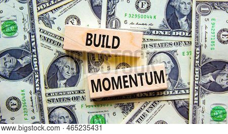 Build Momentum Symbol. Concept Words Build Momentum On Wooden Blocks. Beautiful Background From Doll
