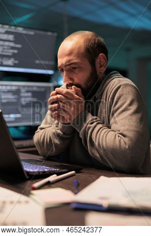 Young Man Feeling Cold And Drinking Cup Of Coffee, Using Hot Beverage To Get Warm In Office Late At 