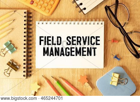 On A Bright Blue Background, Light Wooden Blocks And Cubes With The Text Fsm Field Service Managemen