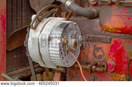 Old And Weathered Alternator Attached To Engine