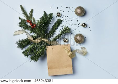 Christmas Decorations On A Blue Background With A Brown Paper Bag And Gold Baknots Around The Tree B