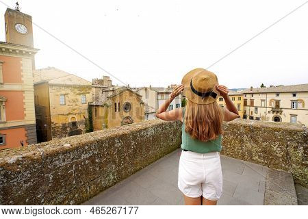 Traveler Girl Enjoying Townscape Of Orvieto From A Terrace Of Historic Palace, Orvieto, Umbria, Ital