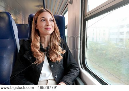 Portrait Of Young Satisfied Woman Traveling With Public Transport Sitting Relaxed Thoughtless