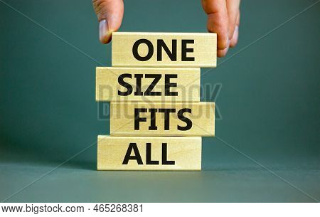 One Size Fits All Symbol. Concept Words One Size Fits All On Wooden Blocks. Businessman Hand. Beauti