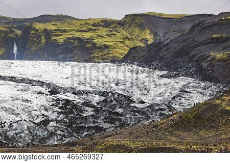 Glacier Meeting Green Covered Hills In Iceland