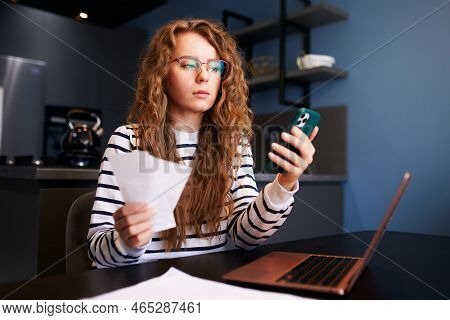 Woman In Eyeglasses Calculates Expenses On Bills, Increased Utilities Prices List. Female Book-keepi